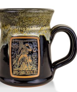The front of the Bones Coffee Company Army of Dark Chocolate Handthrown Mug. It has the Army of Dark Chocolate art on the golden medallion. The mug is gloss black colored with a sunshine and white glaze.