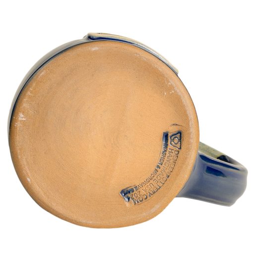 The bottom of the Lucy hand thrown mug. It says Deneen Pottery on the tan bottom.