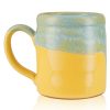 The back of the Bones Coffee Company Bikini Bottom Brew hand thrown mug. It is yellow colored and has a blue and white glaze on top of it.