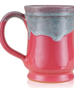 The back of the Bones Coffee Company Soufflé Symphony hand thrown mug. It is cosmo pink colored and has a teal and white glaze on top of it.