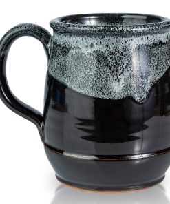 The back of the Dark Side Chocolate Truffle hand thrown mug. It is black colored with a white glaze on top.