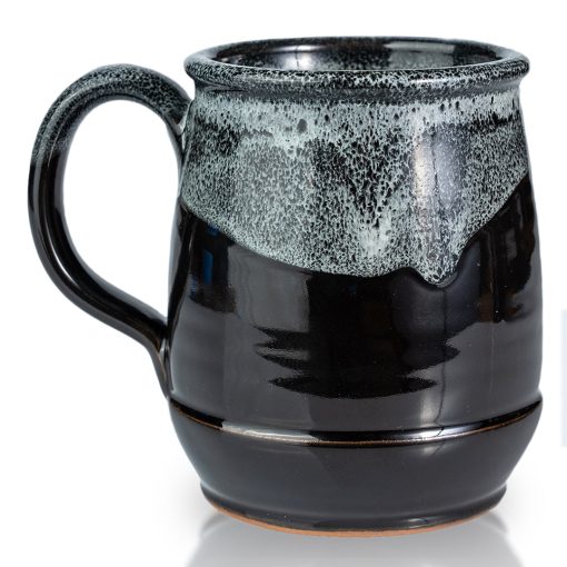 The back of the Dark Side Chocolate Truffle hand thrown mug. It is black colored with a white glaze on top.