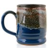 The back of the Bones Coffee Company S’morey Time hand thrown mug. It is a blue color with a cinnamon and white glaze on top of it.