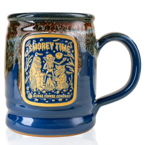 The front of the Bones Coffee Company S’morey Time Handthrown Mug. It has the S’morey Time art on the golden medallion. The mug is blue colored with a cinnamon and white glaze.