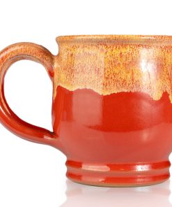 The back of the Twin Sun Tiramisu hand thrown mug. It is paprika colored with a yellow glaze on top.