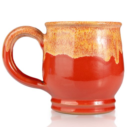 The back of the Twin Sun Tiramisu hand thrown mug. It is paprika colored with a yellow glaze on top.