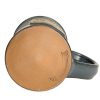 The bottom of the Maximus hand thrown mug. It says Deneen Pottery on the tan bottom.