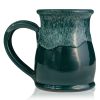 The back of the Frog’s Breath hand thrown mug. It is green colored with a white glaze on top.