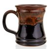 The back of the Bones Coffee Company Murder Hornet hand thrown mug. It is a black colored with a sunset orange glaze on top of it.