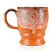 The back of the Jacked O’ Lantern hand thrown mug. It is orange colored with a pumpkin spice glaze on top.