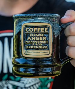 The Anger Management handthrown mug. It is being held up.