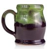 The back of the Mudslide Boogie hand thrown mug. It is plum colored with a kiwi glaze on top.