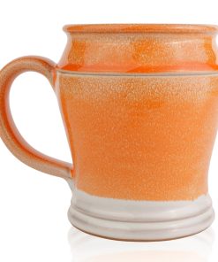 The back of the Orange-Sickle hand thrown mug. It is white colored with an orange glaze on top.