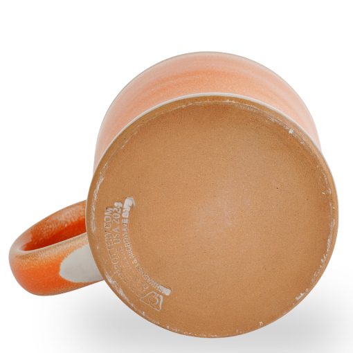The bottom of the Orange-Sickle hand thrown mug. It says Deneen Pottery on the tan bottom.