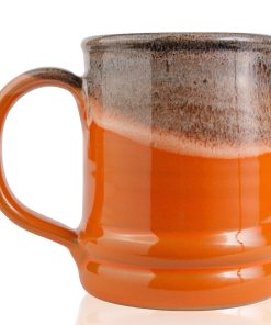 The back of the Pumpkin King hand thrown mug. It is orange colored with a black and white glaze on top.