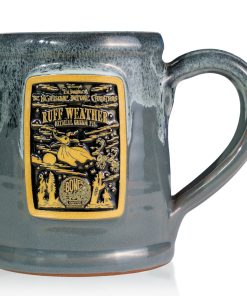 The front of the Bones Coffee Company Ruff Weather hand thrown mug with Zero the dog from Tim Burton’s The Nightmare Before Christmas on the golden medallion. The mug is grey colored with a black and white glaze on top.